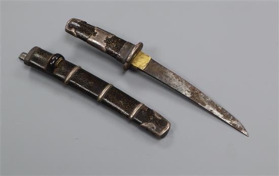 A white metal mounted miniature katana